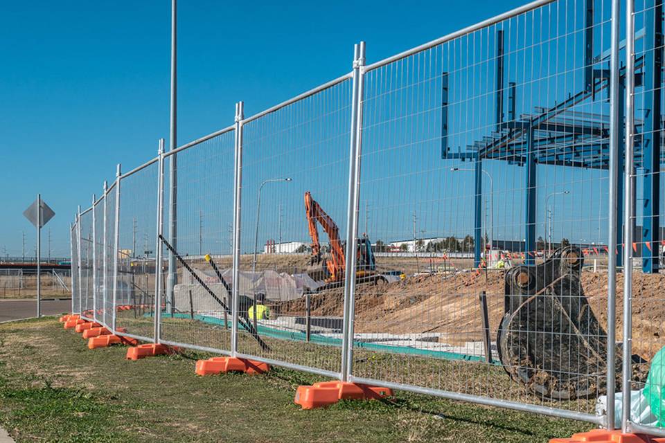 Temporary fence panels installed along a construction perimeter.